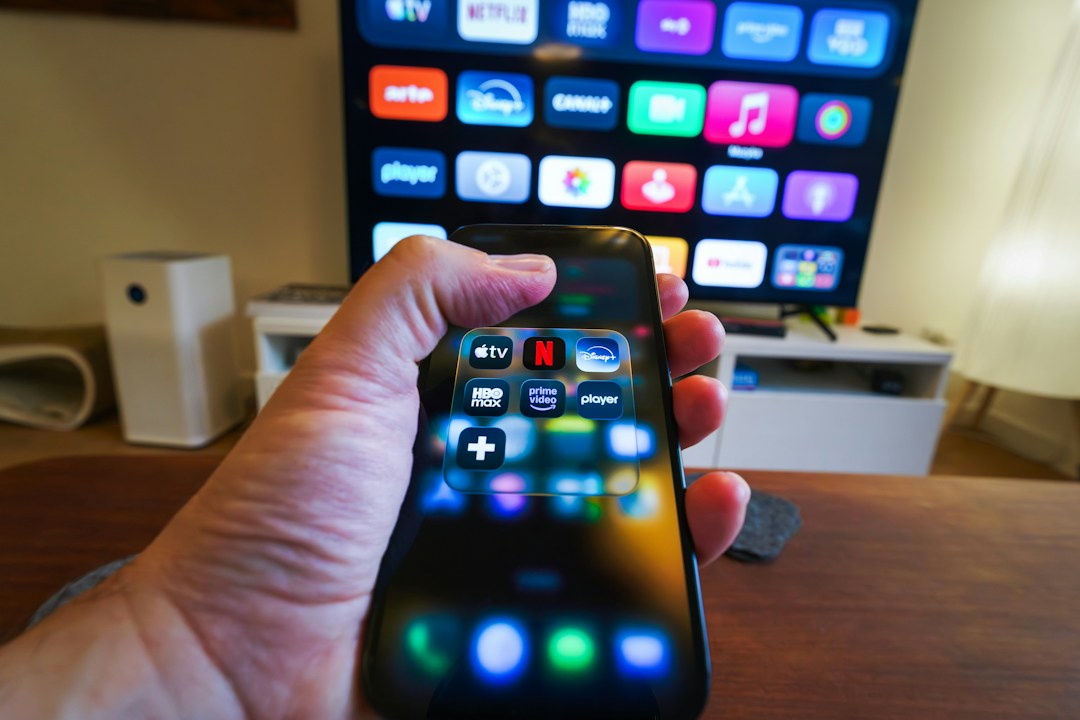 Modern television and smartphone streaming setup for Apple TV IPTV